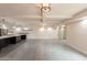 Open concept living room with tiled floors, beamed ceiling, and modern fixtures at 7960 E Camelback Rd # 110, Scottsdale, AZ 85251