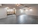 Open living room area with gray tile, and sliding door access to balcony at 7960 E Camelback Rd # 110, Scottsdale, AZ 85251