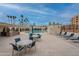 Community pool area featuring tables, chairs, lounge chairs, and a bbq area all around the pool at 7960 E Camelback Rd # 110, Scottsdale, AZ 85251