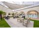 Outdoor seating around poolside with shade canopies, lounge chairs, and well-maintained landscaping at 7960 E Camelback Rd # 110, Scottsdale, AZ 85251