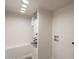 Utility room with modern lighting, white walls, and a utility hookup at 7960 E Camelback Rd # 110, Scottsdale, AZ 85251