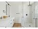 Modern bathroom featuring a dual sink vanity, updated fixtures, and a glass-enclosed shower with marble-look tiling at 10832 N 37Th St, Phoenix, AZ 85028