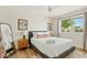 Bedroom featuring a plush bed, sleek window view, and artistic wall decor at 10832 N 37Th St, Phoenix, AZ 85028