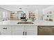 Elegant kitchen island with a sink and stainless steel dishwasher, adjacent to the dining area at 10832 N 37Th St, Phoenix, AZ 85028