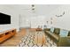 Open-concept living room with wood flooring, modern furniture, and ample natural light at 10832 N 37Th St, Phoenix, AZ 85028