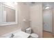 Bright bathroom featuring a large mirror, a toilet, and under sink storage at 1123 N Agave St, Casa Grande, AZ 85122