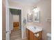 Classic bathroom featuring tile floors, mirrored vanity, and a connecting door at 1123 N Agave St, Casa Grande, AZ 85122