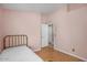 Bedroom featuring a comfortable bed, wood floors, and neutral paint at 1123 N Agave St, Casa Grande, AZ 85122