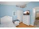 Comfortable bedroom features a TV, matching white dresser and light blue painted walls at 1123 N Agave St, Casa Grande, AZ 85122