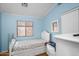 Modest bedroom with light blue walls featuring a single window and closet with sliding doors at 1123 N Agave St, Casa Grande, AZ 85122