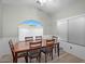 Traditional dining room with wood floors, arched window, and seating for six at 1123 N Agave St, Casa Grande, AZ 85122