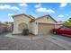 Charming single-Gathering home with a two-car garage, desert landscaping, and a paved driveway at 1123 N Agave St, Casa Grande, AZ 85122