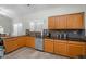 Bright kitchen with laminate flooring, stainless steel appliances, and wooden cabinetry at 1123 N Agave St, Casa Grande, AZ 85122