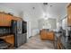 Bright kitchen with stainless steel refrigerator, granite countertops, and a spacious eating area at 1123 N Agave St, Casa Grande, AZ 85122