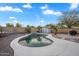 Backyard pool with desert landscaping featuring an artificial rock waterfall and white coping at 1123 N Agave St, Casa Grande, AZ 85122