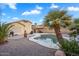 Backyard pool with desert landscaping, a tan home, and a cloudy blue sky at 1123 N Agave St, Casa Grande, AZ 85122