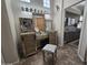 Bathroom with a vanity featuring multiple mirrors, decorative lighting, and a white stool at 11390 N 78Th St, Scottsdale, AZ 85260