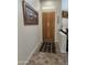 Inviting entryway with a wood door, tile flooring, and decorative artwork at 11390 N 78Th St, Scottsdale, AZ 85260