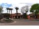 Exterior of a community building with manicured landscaping, palm trees, and ample parking at 11390 N 78Th St, Scottsdale, AZ 85260