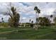 Lush green golf course with walking path, trees and distant view of the houses at 11390 N 78Th St, Scottsdale, AZ 85260