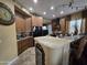 Modern kitchen with dark wood cabinets, black appliances, granite countertops, and an island with barstool seating at 11390 N 78Th St, Scottsdale, AZ 85260