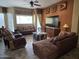 Living room with decorative wall trim, a ceiling fan, and plush furniture create a cozy and inviting space at 11390 N 78Th St, Scottsdale, AZ 85260