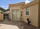 A cozy outdoor patio with a tiled surface showcases a desert-style garden and leads to a gated entrance at 11390 N 78Th St, Scottsdale, AZ 85260