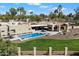 Aerial view of property, featuring pool, spa, landscaping, and lush lawn at 11416 N Blackheath Rd, Scottsdale, AZ 85254
