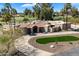 An aerial view showcasing the layout of the home, driveway, landscaping, and palm trees at 11416 N Blackheath Rd, Scottsdale, AZ 85254