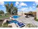 Aerial view of the pool, spa, fire features, and manicured landscaping in the backyard at 11416 N Blackheath Rd, Scottsdale, AZ 85254