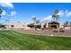 An exterior view of the home showcasing the back yard, desert landscaping and palm trees at 11416 N Blackheath Rd, Scottsdale, AZ 85254