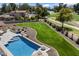 Expansive backyard featuring a pool, manicured lawn, and scenic golf course views, perfect for outdoor enjoyment at 11416 N Blackheath Rd, Scottsdale, AZ 85254