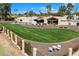 Expansive fenced backyard featuring lush lawn and elegant landscaping at 11416 N Blackheath Rd, Scottsdale, AZ 85254