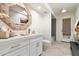 Well-lit bathroom with a decorative mirror, quartz countertop, and modern fixtures at 11416 N Blackheath Rd, Scottsdale, AZ 85254