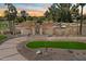 A stunning desert home features a circular driveway with drought-resistant landscaping and an attractive front entrance at 11416 N Blackheath Rd, Scottsdale, AZ 85254
