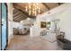 Welcoming foyer boasts a high ceiling with wooden beams, neutral tile flooring, and an open view of the living area at 11416 N Blackheath Rd, Scottsdale, AZ 85254