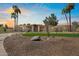 Charming single-story home featuring a well-manicured front yard, desert landscaping, and palm trees at 11416 N Blackheath Rd, Scottsdale, AZ 85254