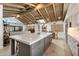 A spacious kitchen features a large center island, stainless steel appliances, and flows into a comfortable living area at 11416 N Blackheath Rd, Scottsdale, AZ 85254