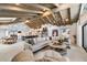 Spacious living room features an open-concept design with a beamed ceiling, large sofa, and adjacent kitchen at 11416 N Blackheath Rd, Scottsdale, AZ 85254