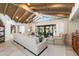 Open-concept living room featuring a vaulted wood ceiling and seamless indoor-outdoor flow at 11416 N Blackheath Rd, Scottsdale, AZ 85254