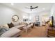 Bright living room features a neutral sectional, ceiling fan, and view of the bedroom at 11416 N Blackheath Rd, Scottsdale, AZ 85254