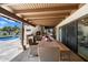 Elegant outdoor patio with a dining area, outdoor kitchen, and refreshing pool view at 11416 N Blackheath Rd, Scottsdale, AZ 85254