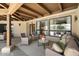 Covered patio featuring a cozy seating area with an eye to a well-manicured lawn at 11416 N Blackheath Rd, Scottsdale, AZ 85254