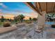 Inviting patio with comfortable seating, manicured landscaping, and scenic golf course views at sunset at 11416 N Blackheath Rd, Scottsdale, AZ 85254