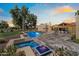 Expansive backyard featuring a pool, spa, fire features, and meticulously manicured landscaping at 11416 N Blackheath Rd, Scottsdale, AZ 85254