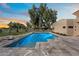 Lush backyard pool with elegant tiling, complemented by trees and a tranquil setting at 11416 N Blackheath Rd, Scottsdale, AZ 85254