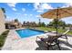 Sparkling pool with lounge chairs and umbrella for relaxation, set against a beautiful lawn at 11416 N Blackheath Rd, Scottsdale, AZ 85254