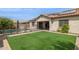 Serene backyard with pool, artificial turf, and a covered patio area at 11609 W Andrew Ln, Peoria, AZ 85383