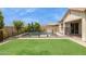 Landscaped backyard featuring a refreshing swimming pool surrounded by lush green grass at 11609 W Andrew Ln, Peoria, AZ 85383