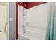 Bright bathroom featuring a shower-tub combination with a modern shower head and a white shower curtain at 11609 W Andrew Ln, Peoria, AZ 85383
